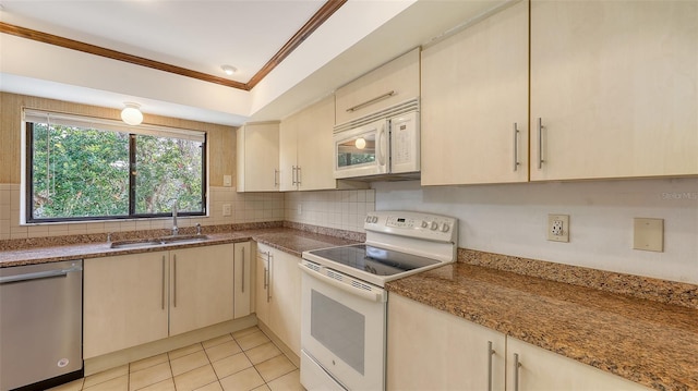 kitchen with decorative backsplash, ornamental molding, light tile patterned flooring, a sink, and white appliances