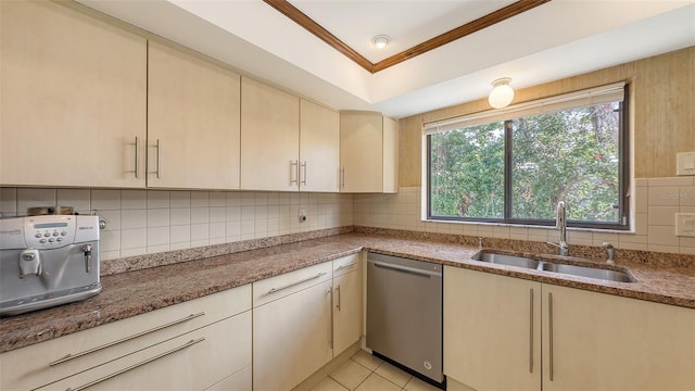 kitchen with dishwasher, tasteful backsplash, a sink, and light stone countertops