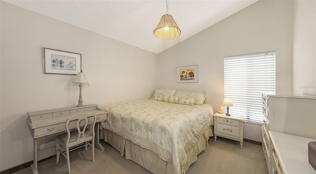 bedroom with vaulted ceiling, light carpet, and baseboards