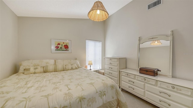 bedroom with vaulted ceiling, carpet flooring, and visible vents