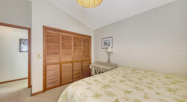 bedroom with light carpet, baseboards, vaulted ceiling, a textured ceiling, and a closet