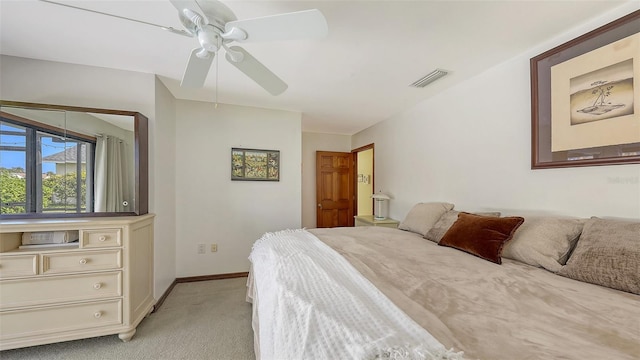 bedroom featuring visible vents, ceiling fan, light carpet, and baseboards