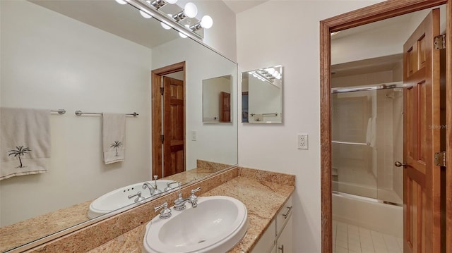 full bath featuring bath / shower combo with glass door and vanity