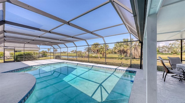 pool featuring glass enclosure and a patio