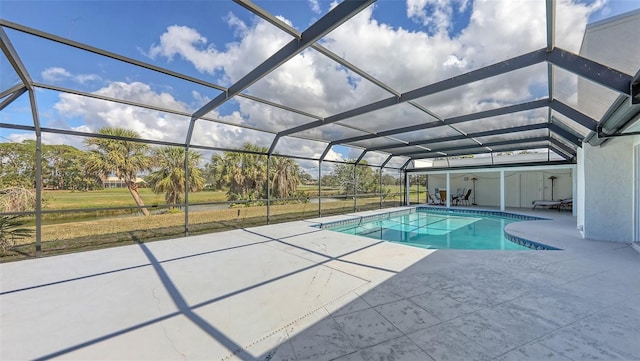 pool with glass enclosure and a patio