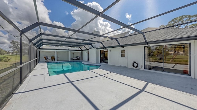 outdoor pool featuring a lanai and a patio area