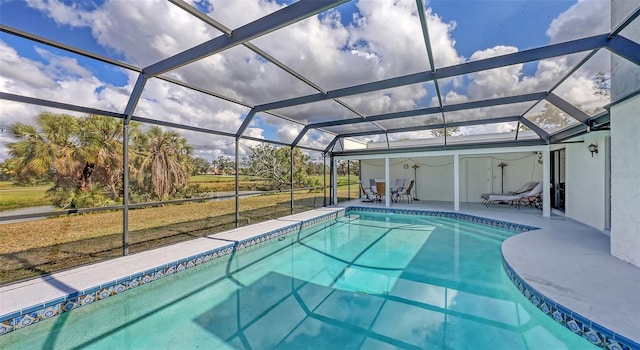 pool with glass enclosure and a patio