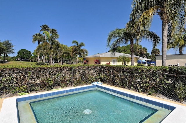 view of pool featuring fence