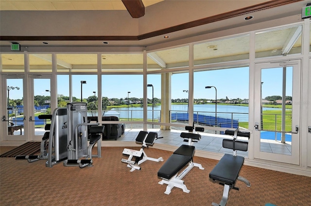 gym with carpet floors, french doors, and a water view