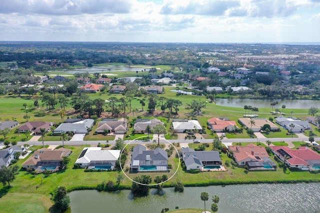 birds eye view of property with a water view and a residential view