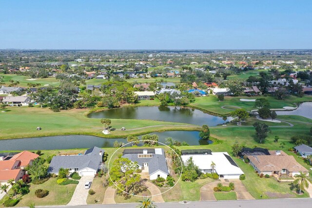 drone / aerial view with view of golf course, a water view, and a residential view