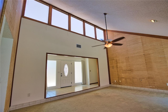 3837 Torrey Pines Blvd, Sarasota, FL 34238 - entrance foyer featuring carpet flooring, high vaulted ceiling, ceiling fan, a textured ceiling, and baseboards