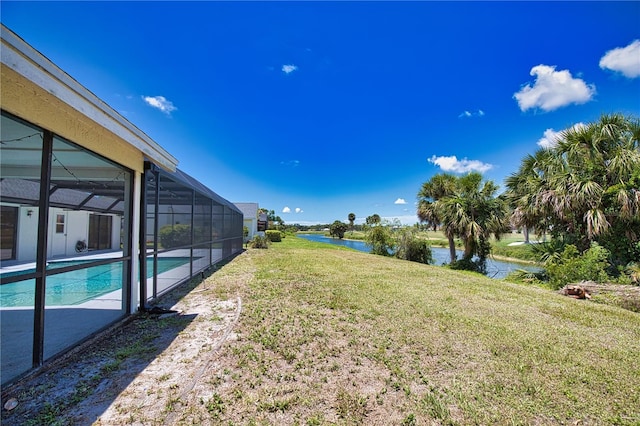 3837 Torrey Pines Blvd, Sarasota, FL 34238 - view of grassy yard featuring a water view, an outdoor pool, a lanai, and a patio area
