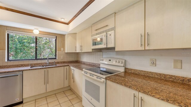 3837 Torrey Pines Blvd, Sarasota, FL 34238 - kitchen with white appliances, a sink, crown molding, tasteful backsplash, and light tile patterned floors