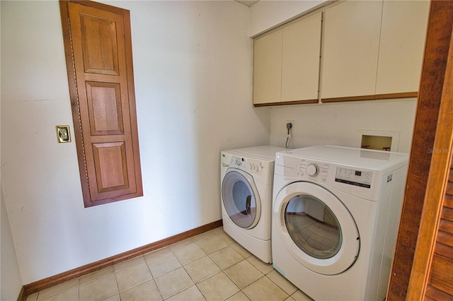 3837 Torrey Pines Blvd, Sarasota, FL 34238 - laundry area with cabinet space, washing machine and dryer, baseboards, and light tile patterned floors