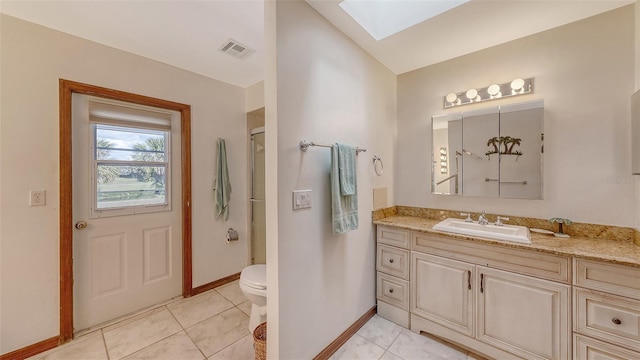3837 Torrey Pines Blvd, Sarasota, FL 34238 - full bathroom featuring a skylight, vanity, baseboards, toilet, and tile patterned flooring
