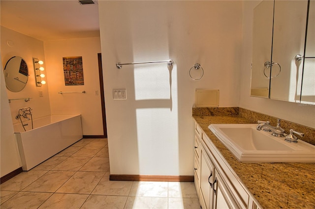 3837 Torrey Pines Blvd, Sarasota, FL 34238 - bathroom with vanity, a garden tub, tile patterned flooring, and baseboards