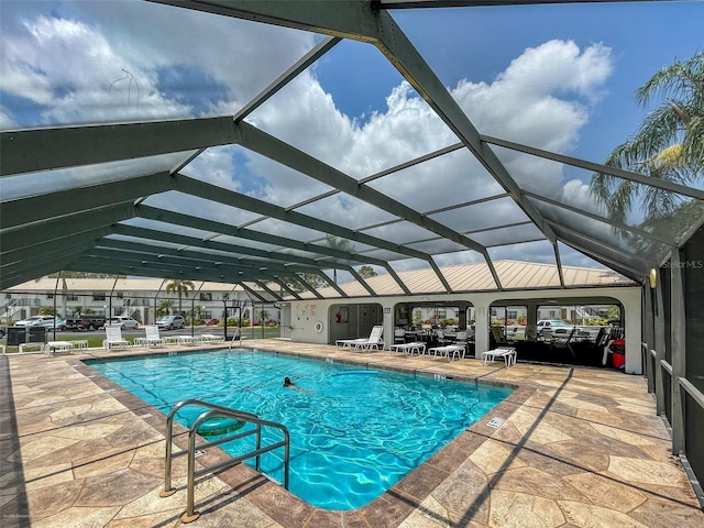 view of swimming pool with a patio and a lanai