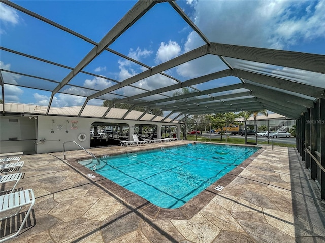 view of swimming pool with a patio and glass enclosure