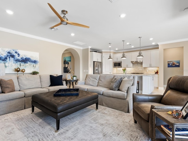 living room featuring crown molding and ceiling fan