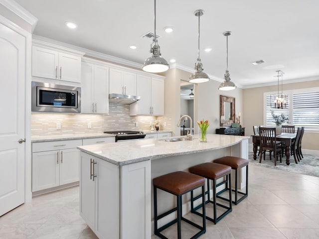 kitchen with white cabinetry, an island with sink, stainless steel appliances, and sink