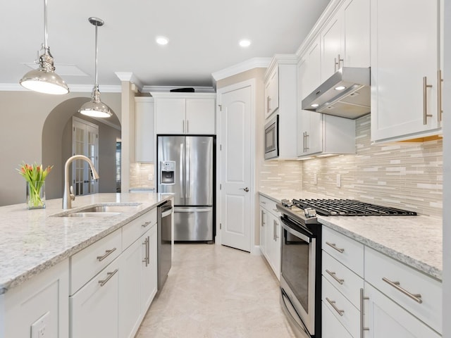 kitchen featuring sink, stainless steel appliances, light stone countertops, white cabinets, and wall chimney exhaust hood