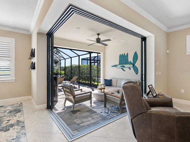 living room with light tile patterned floors, plenty of natural light, ornamental molding, and ceiling fan