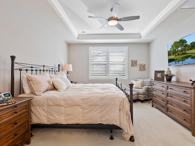 bedroom featuring a raised ceiling, crown molding, light carpet, and ceiling fan