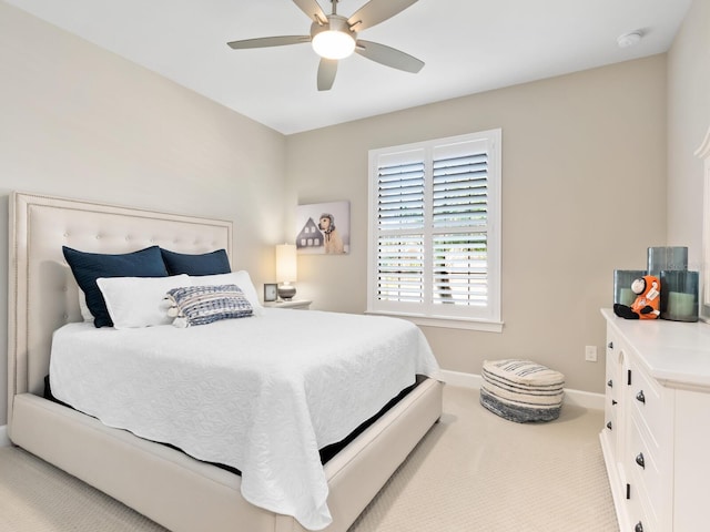 bedroom featuring light carpet and ceiling fan