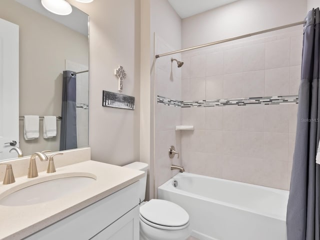 full bathroom featuring vanity, shower / bath combination with curtain, and toilet