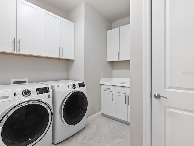 laundry area featuring cabinets and washer and dryer