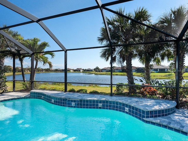 view of swimming pool featuring a water view and glass enclosure