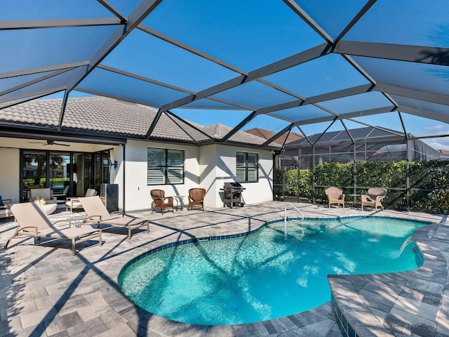 view of pool featuring a grill, a lanai, a patio area, and pool water feature