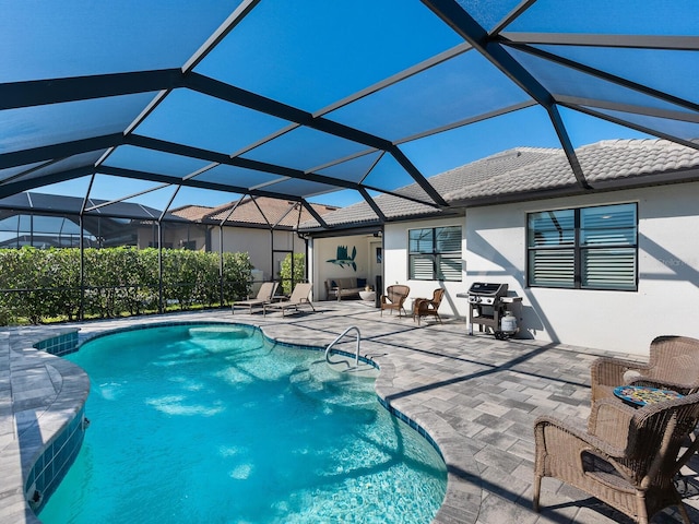 view of swimming pool featuring a patio and glass enclosure