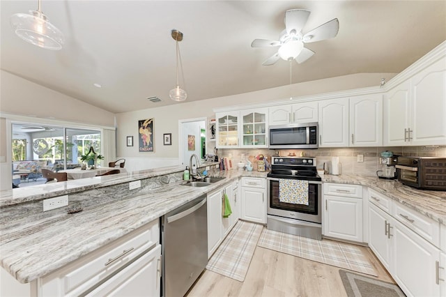 kitchen with pendant lighting, sink, white cabinetry, and appliances with stainless steel finishes