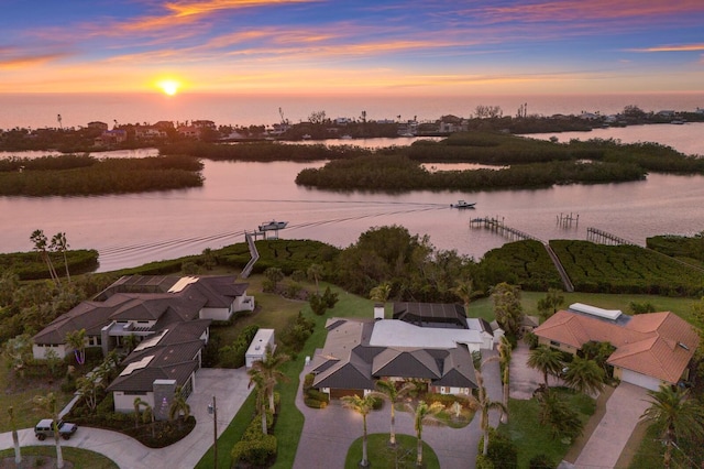 aerial view at dusk with a water view