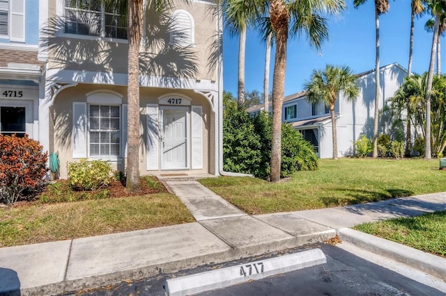 entrance to property featuring a lawn