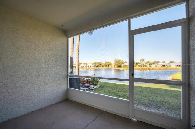 unfurnished sunroom with a water view and plenty of natural light