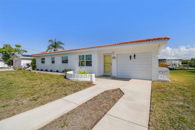 view of front of property with a garage and a front yard