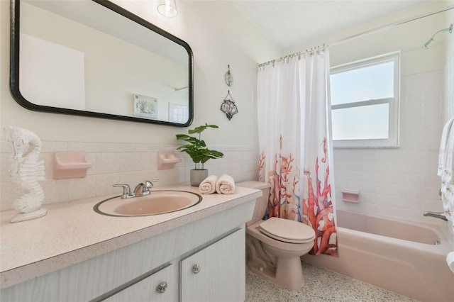 full bathroom featuring vanity, tile walls, shower / tub combo, and toilet