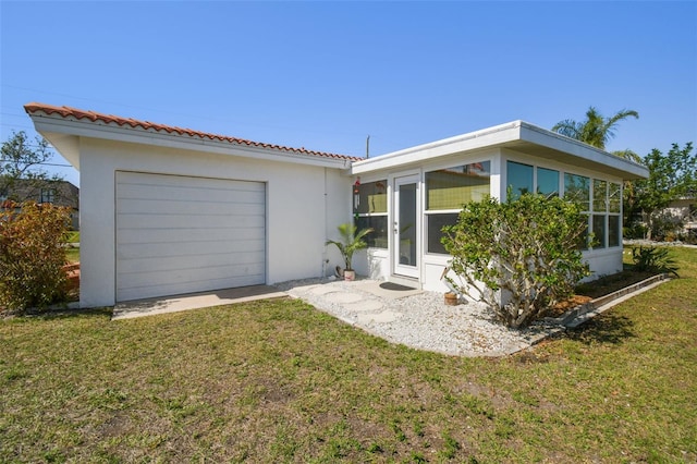 view of front facade with a sunroom and a front yard