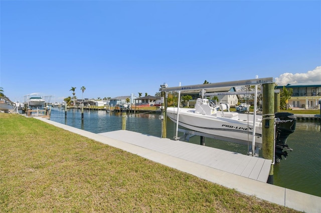 view of dock with a water view and a lawn