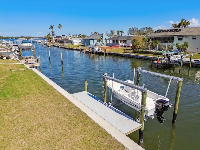 dock area featuring a water view and a lawn