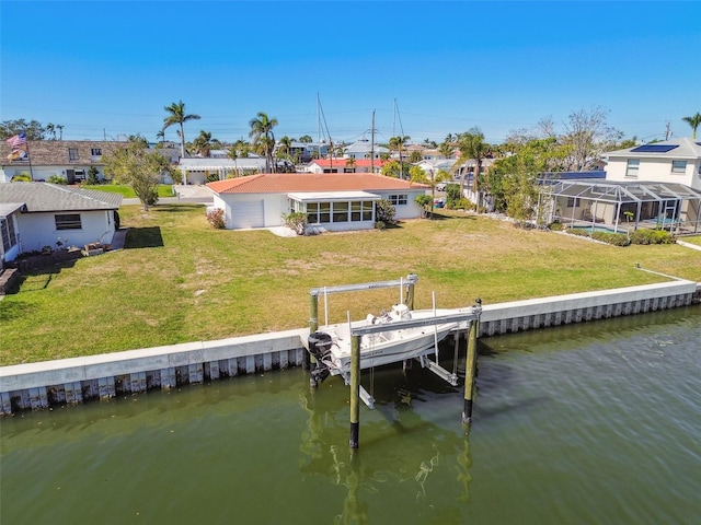 dock area with a water view and a yard