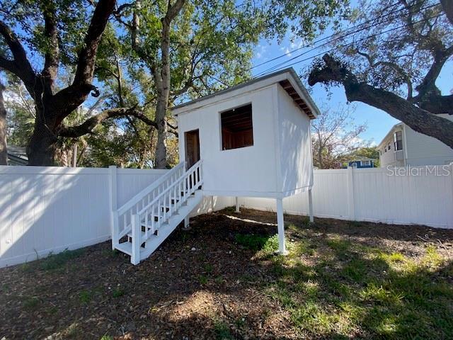 exterior space featuring a fenced backyard and an outdoor structure