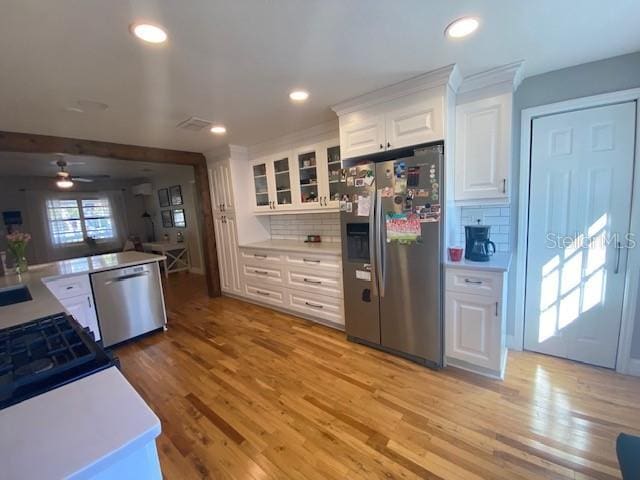 kitchen featuring light wood finished floors, appliances with stainless steel finishes, and light countertops