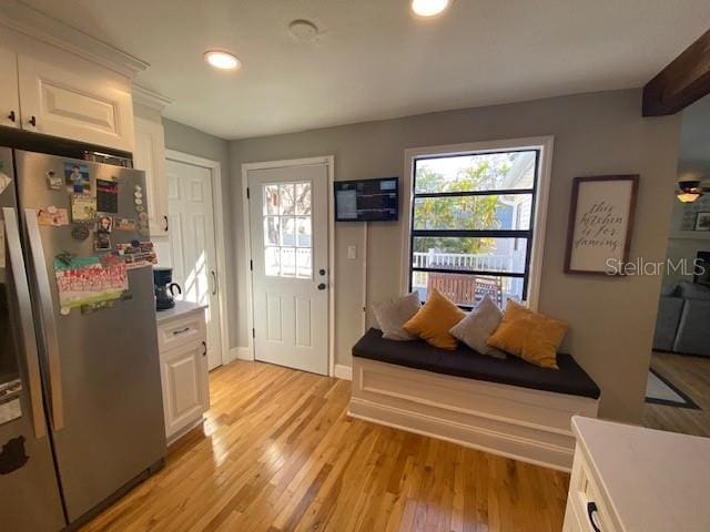 entryway with an AC wall unit, light wood-type flooring, a wealth of natural light, and recessed lighting