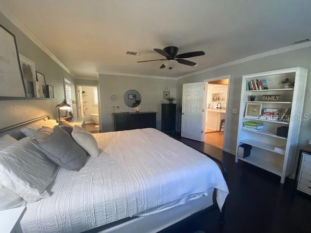 bedroom featuring a ceiling fan, connected bathroom, visible vents, and crown molding