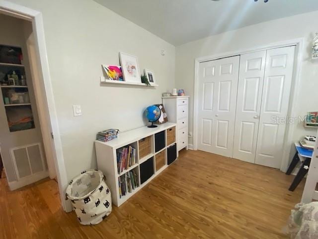 recreation room with visible vents and wood finished floors