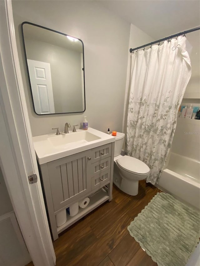 full bathroom featuring vanity, shower / tub combo, wood finished floors, and toilet